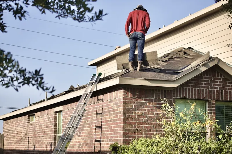 Professional roofer working on a residential roof in Oakwood Lakes